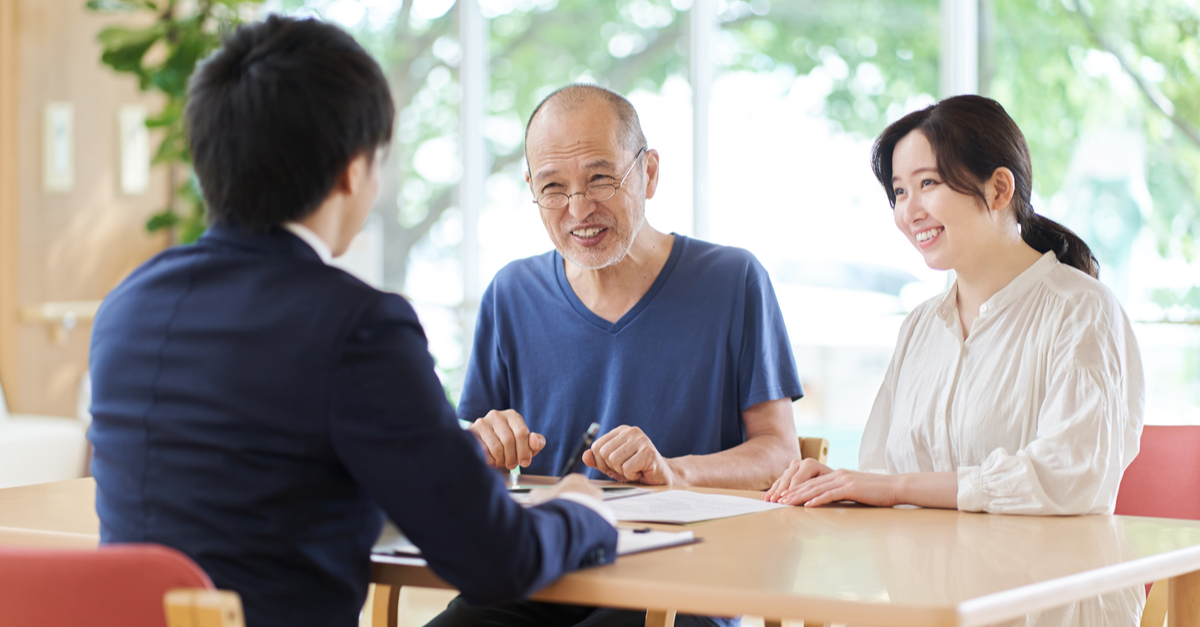 Senior man and his daughter talking to a consultant