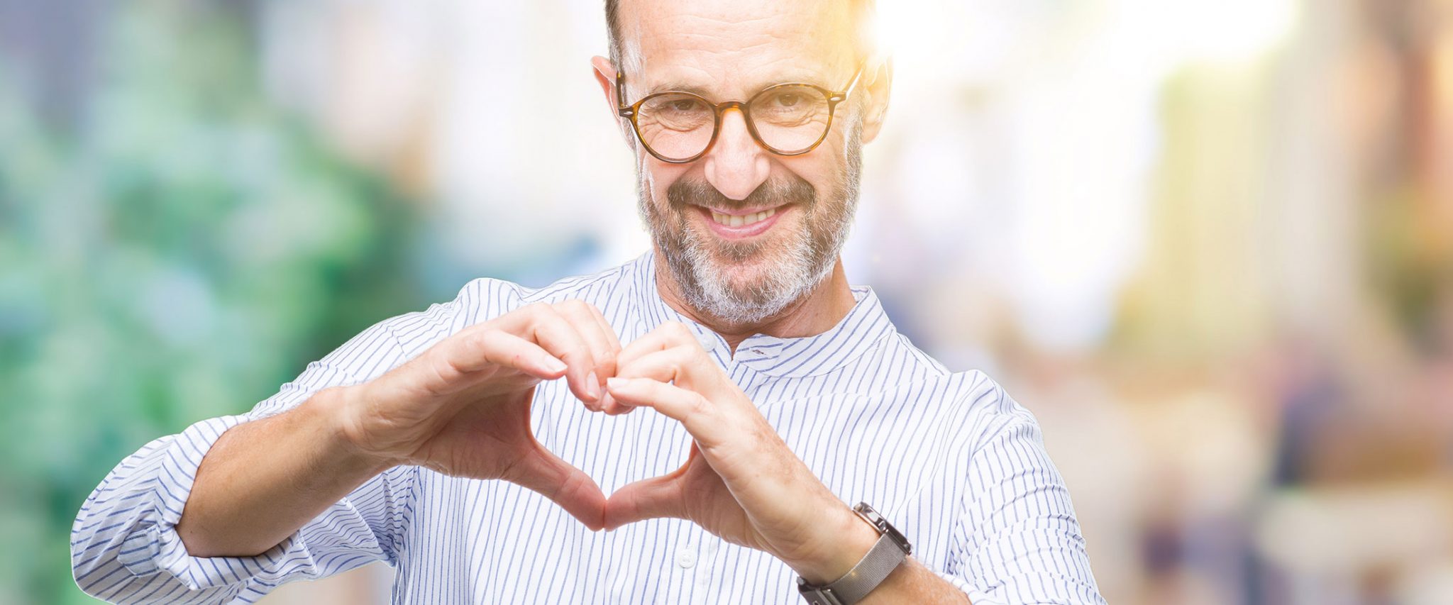 man making a heart shape with his fingers