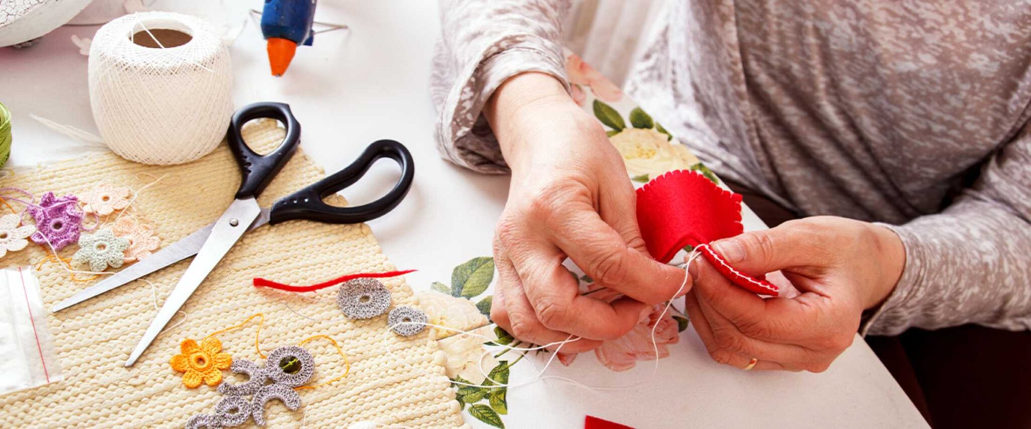 senior crafting with felt and string