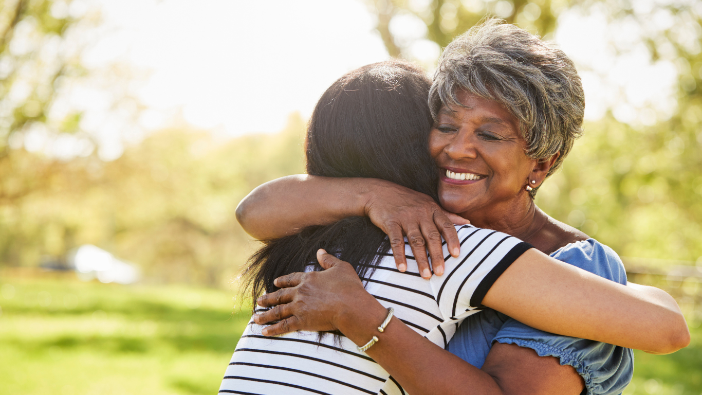 Senior woman hugging adult daughter