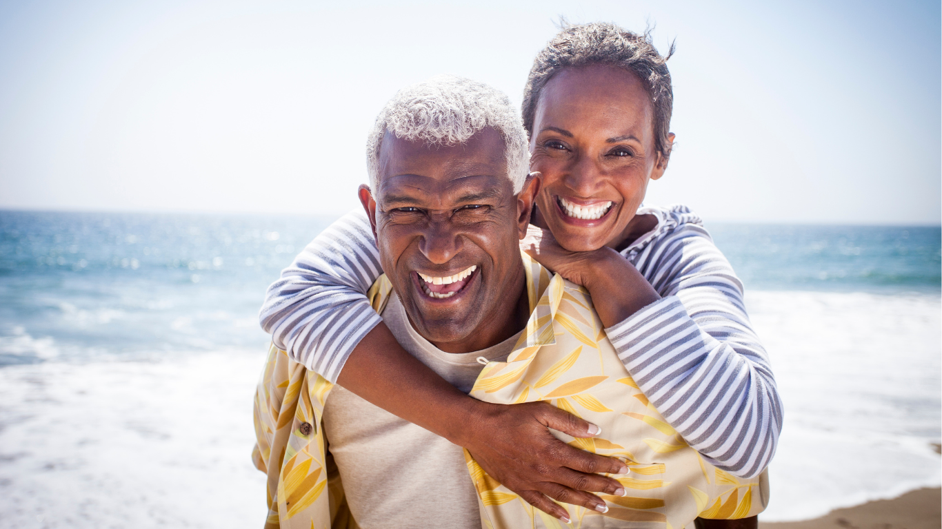 Smiling senior couple at beach