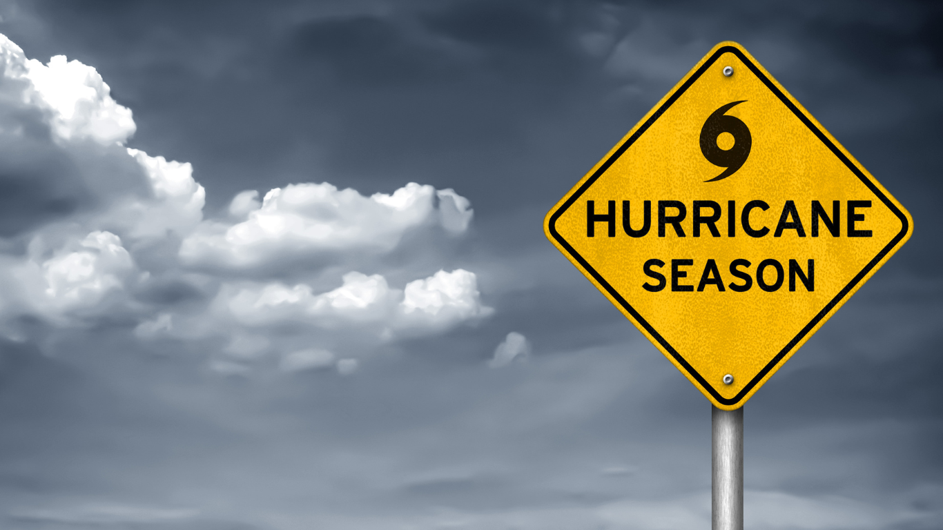 Blog Images (81) A sign that reads hurricane season in a stormy setting