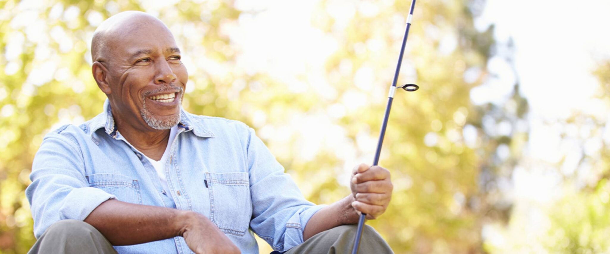 senior man fishing with adaptive fishing equipment in his retirement community