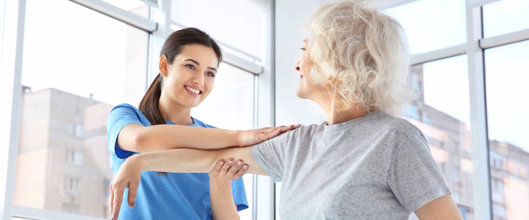 senior at a senior rehabilitation center with a licensed physical therapist