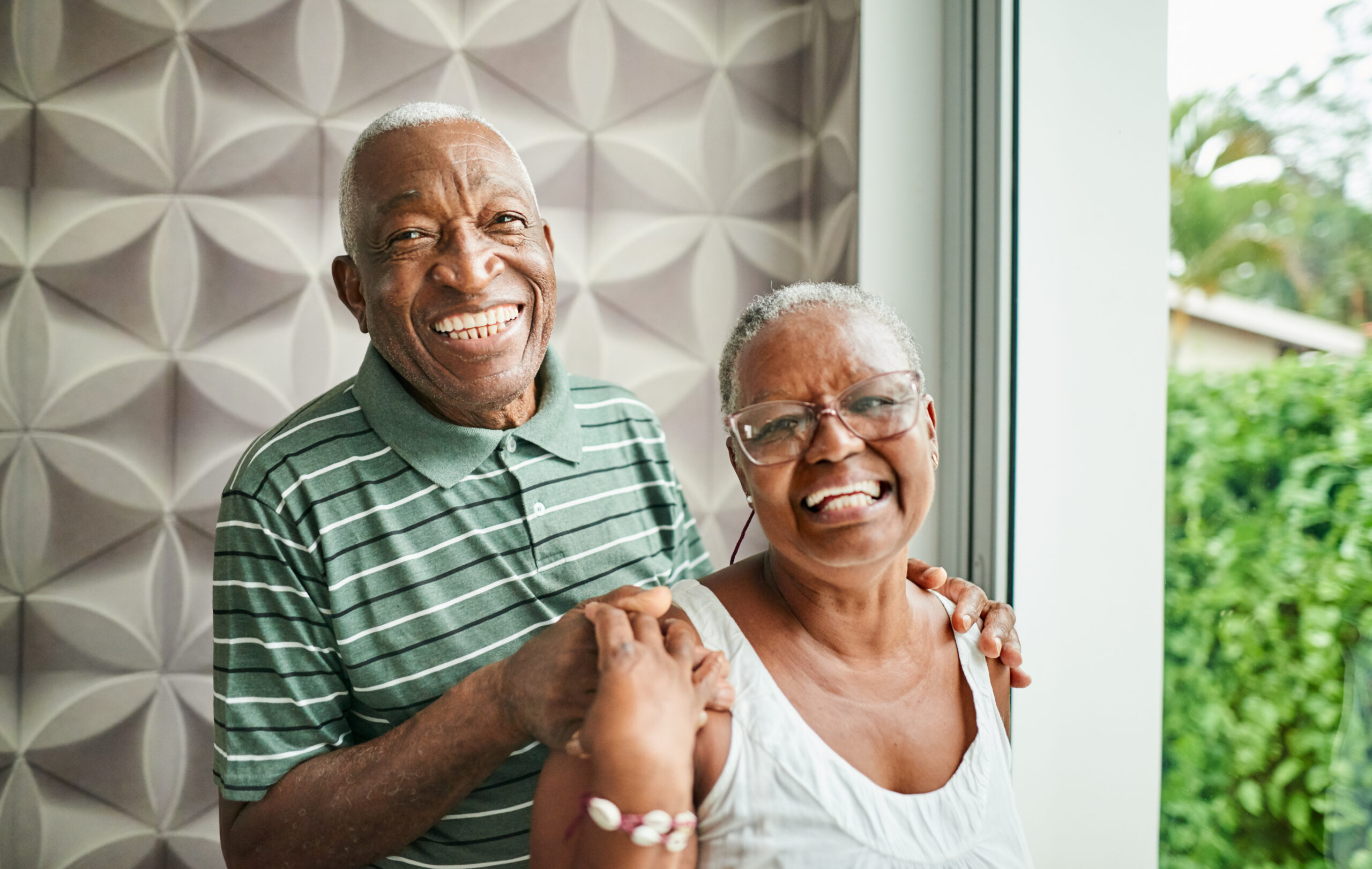 A couple happily standing and holding hands