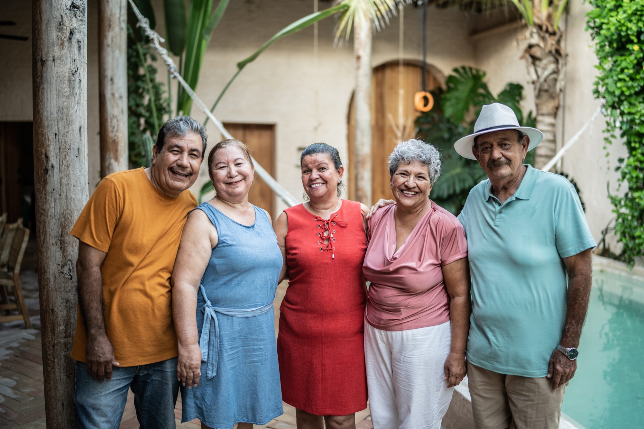 Group of smiling senior friends by the pool