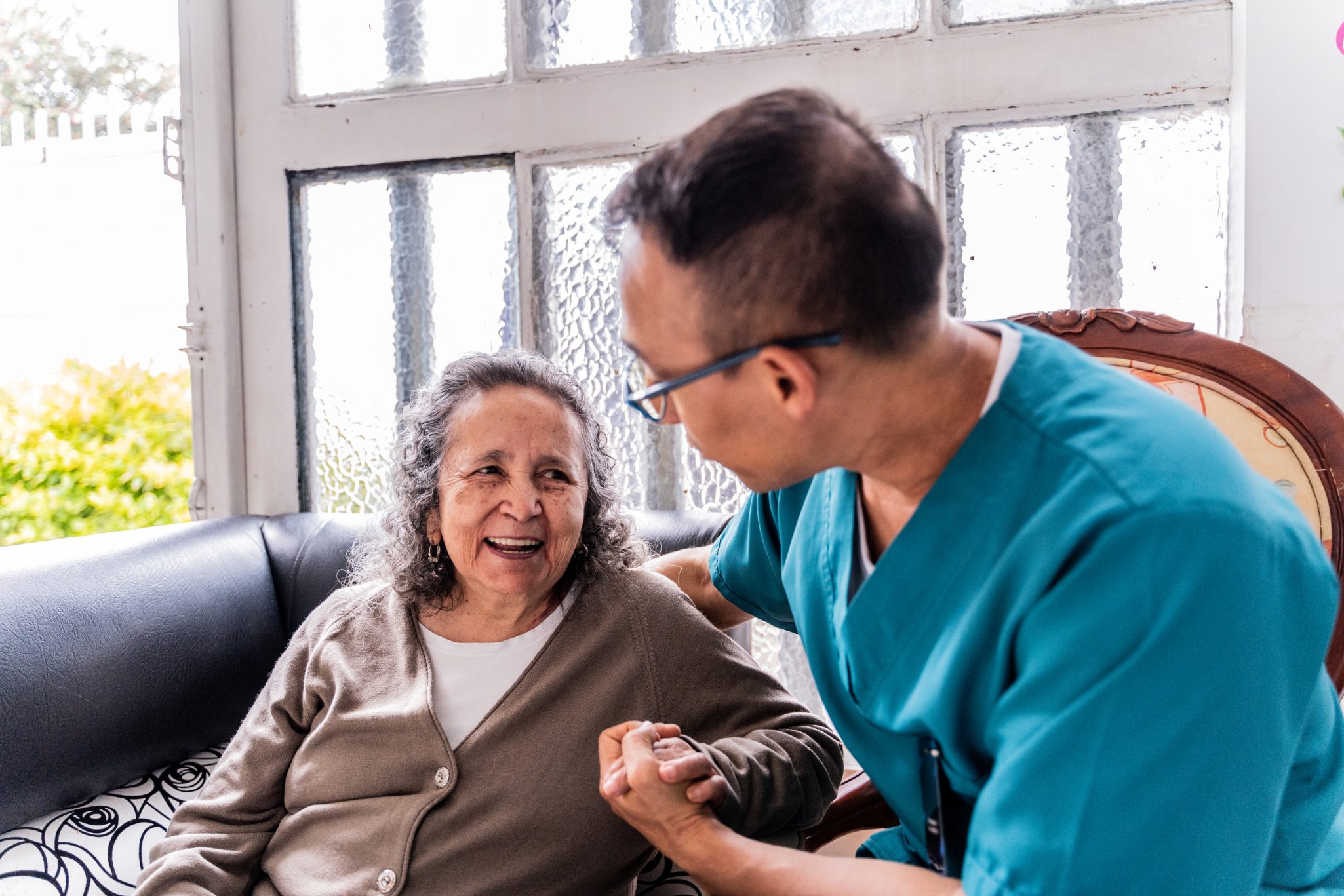Senior woman receiving assistance from male healthcare worker