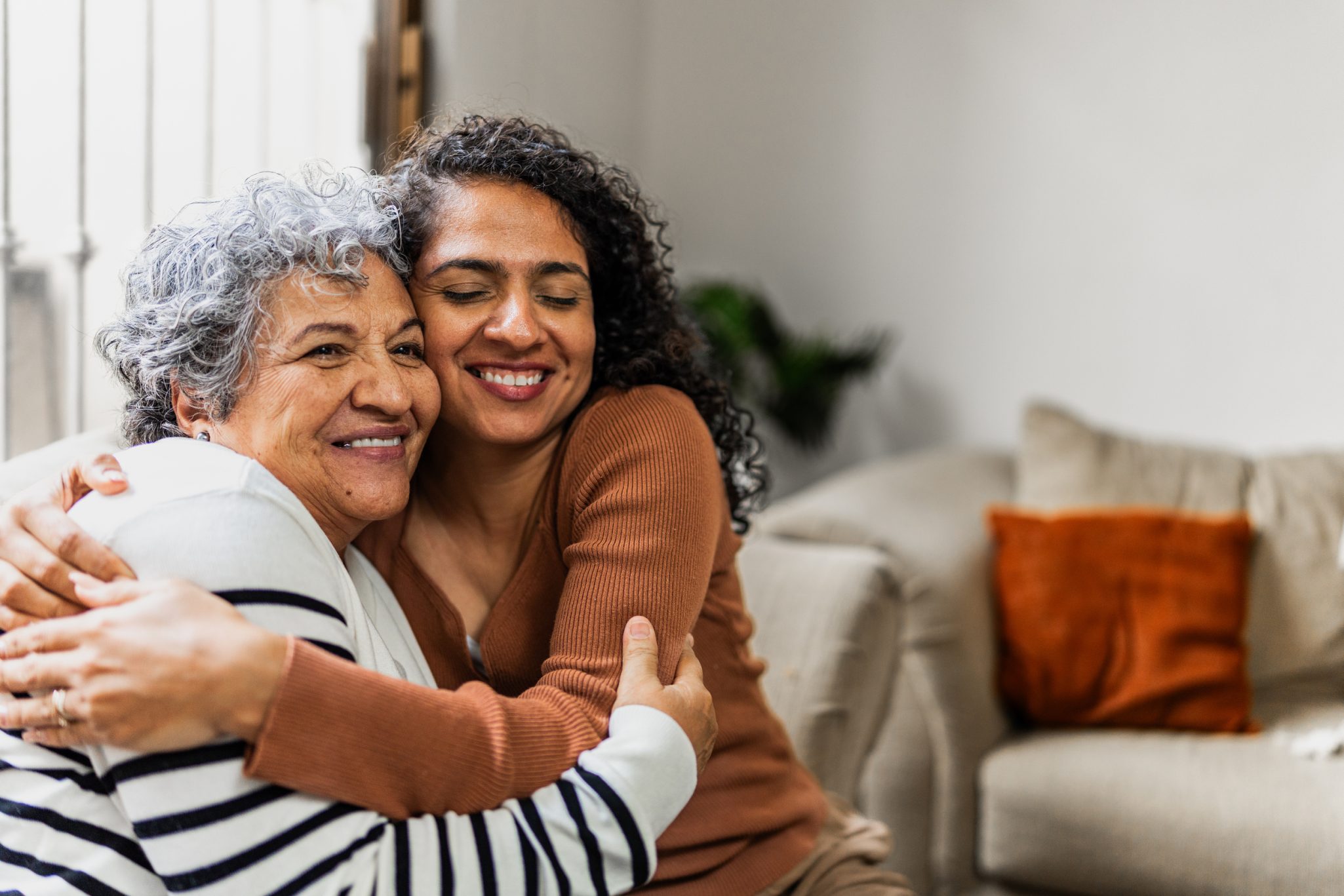 Senior mother embracing adult daughter